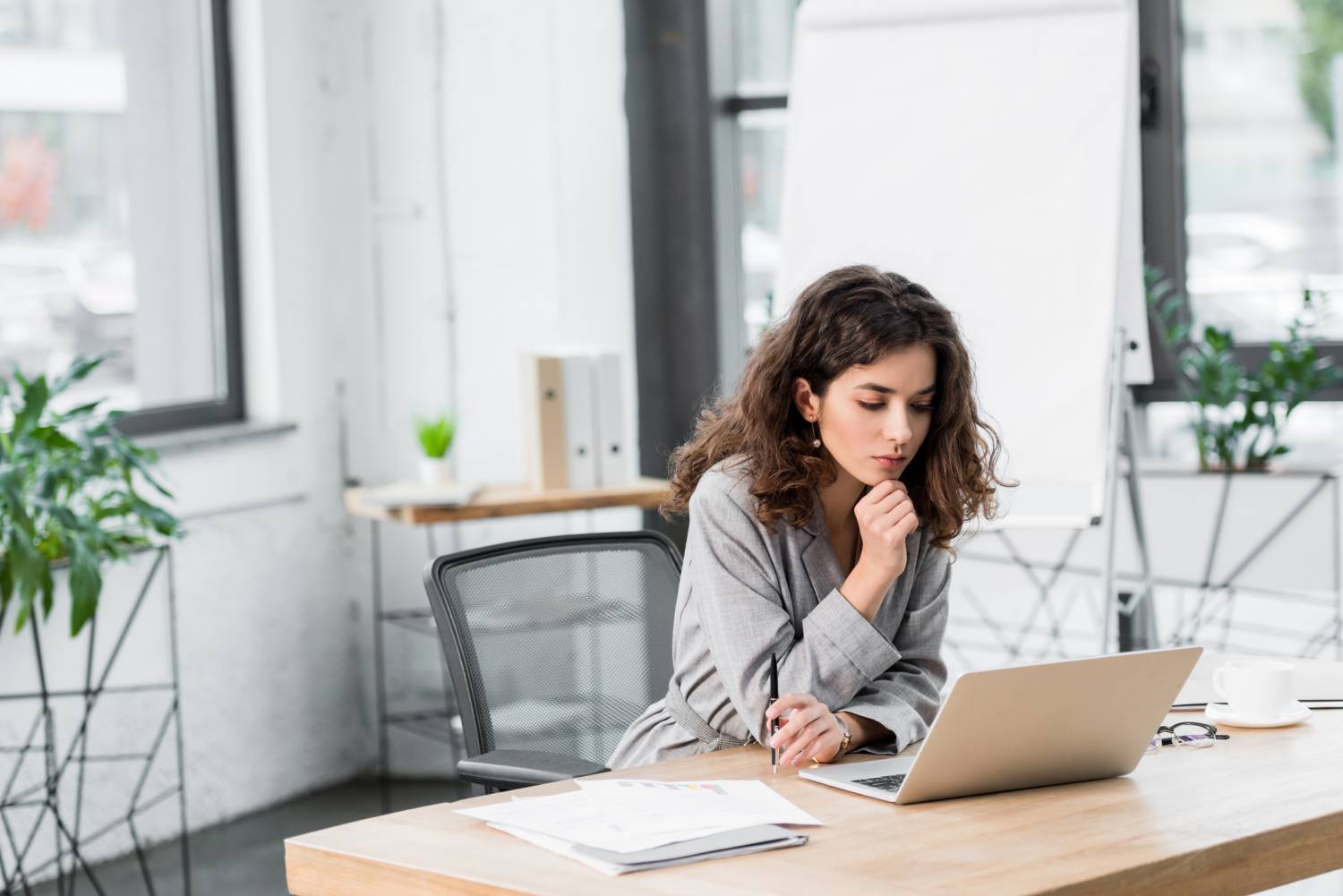 pensive-account-manager-sitting-at-table-and-looki-2022-11-02-03-51-16-utc (1)
